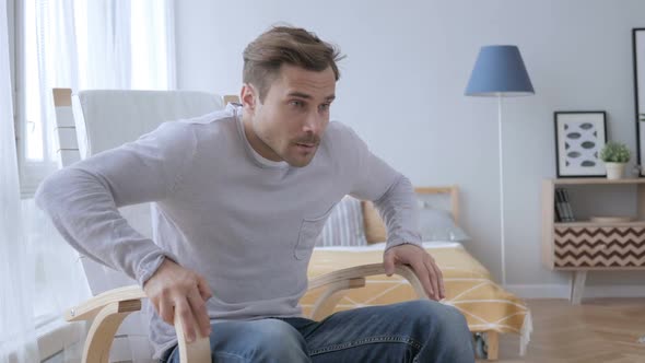 Adult Man Leaving Relaxing Chair in Bedroom