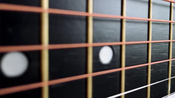 Zoom in Shot of Black Frets Fretboard Acoustic Guitar String