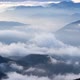 Clouds Spill Over the Tops of the Hills in the Light of the Rising Sun Mystical Morning Landscape - VideoHive Item for Sale