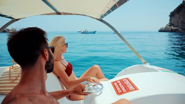 Couple Relaxing On Sea.Sea Vacation Wibe.Couple On Catamaran.Honeymoon Trip Adventure On Italy