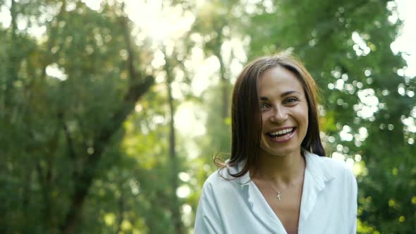 Close Up Portrait of Smiling and Joyful Feminine Girl Looking To Camera in Autumn Park. Attractive