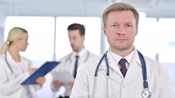 Portrait of Serious Male Doctor Looking at the Camera