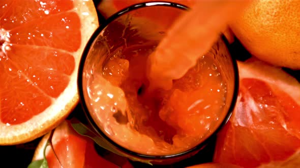 Super Slow Motion Grapefruit Juice Poured Into the Glass Whirlpool