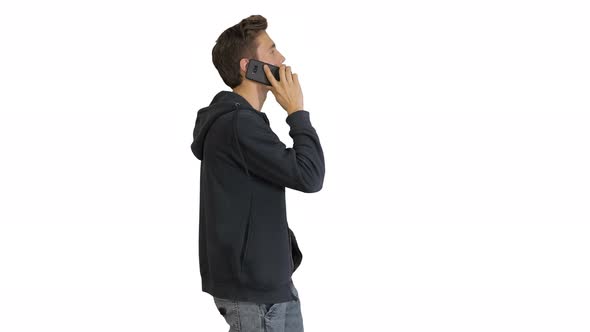 Casual Man Talking on Mobile Phone While Walking on White Background