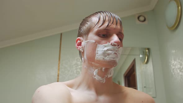 Man Shaves Face