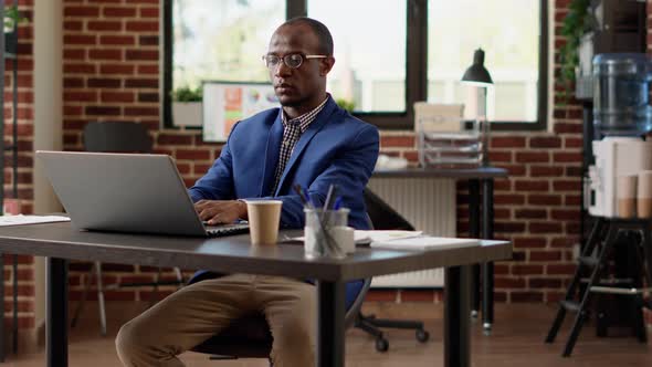 Portrait of Executive Assistant Using Online Website on Laptop