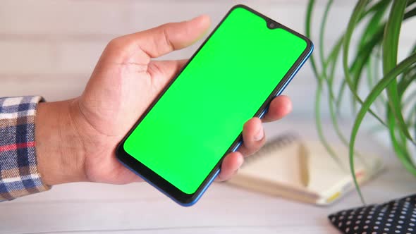 Top View of Man Hand Using Smart Phone on Office Desk