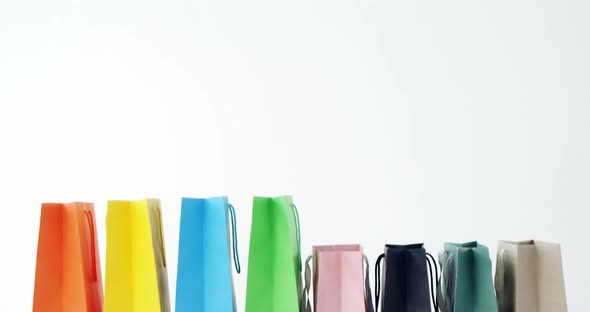 Multicolored shopping bags on white background