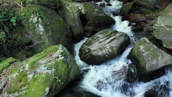 Drone flzing above Mountain river, rocks and boulders in forest, Bistriski Vintgar gorge on Pohorje,