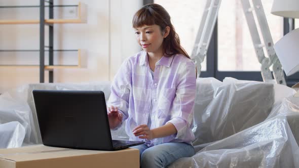 Woman with Laptop Moving Into New Home