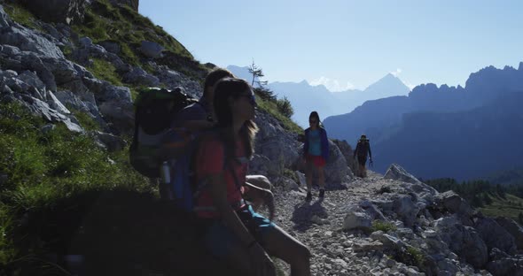 Four Friends Walking Along Hiking Trail Path and Relax