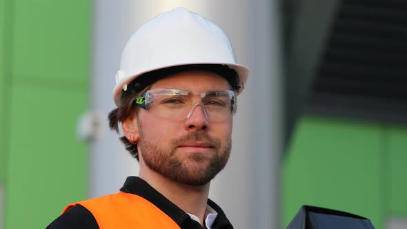 Portrait of smiling engineer wearing helmet