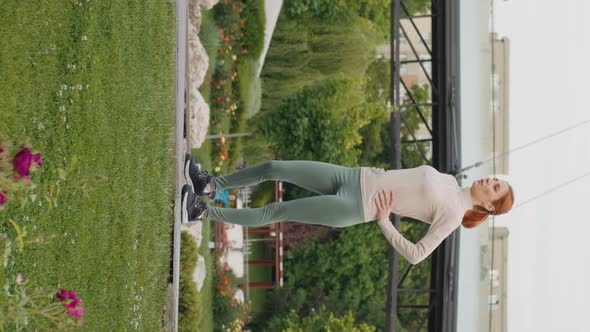 Vertical Screen Young woman stops running to take a break in the park.