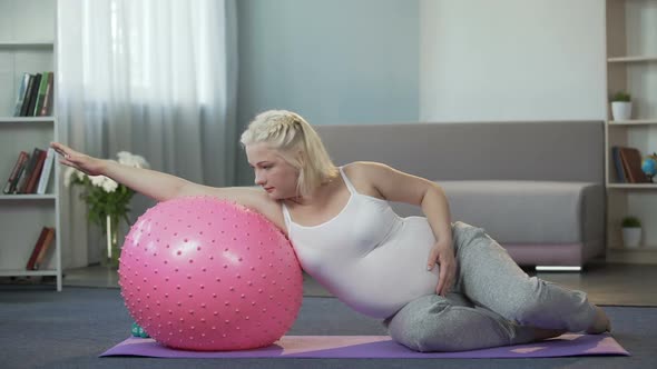 Pregnant Girl Doing Exercises at Home, Removing Tension From Her Tired Body