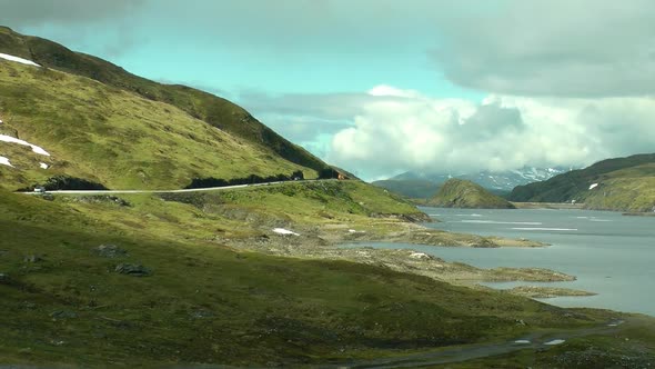 Beautiful landscape in Norway with lake and road. Road in the mountains of Norway.