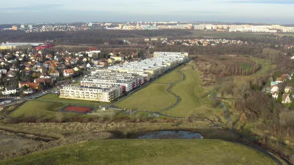 Aerial Shot of Part of the City with Modern Apartment Buildings and Surrounding Nature