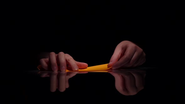 Person Makes Origami. Black. Closeup