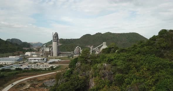 Aerial flight showing giant cement industry outside district area in countryside