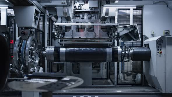 Robotic Tyre Plant Worker Operating Production Process in Factory Close Up