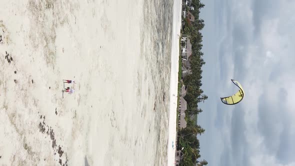 Vertical Video Kitesurfing Near the Shore of Zanzibar Tanzania Aerial View