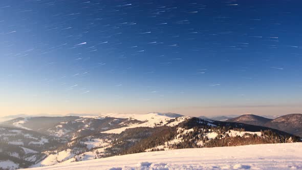 Fog Moving Over the Mountain in Winter with a Starshaped Sky