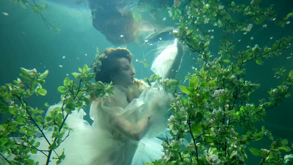 Charming Beautiful Lady is Floating Alone in Fabulous Underwater Garden Slow Motion Shot