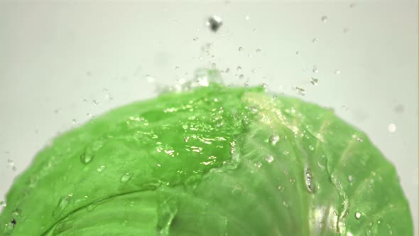 Super Slow Motion on the Fork of Cabbage on a White Background Drop Drops of Water