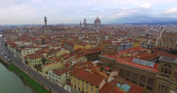 Drone Flight Across the Arno River and Above the Roofs of Italian Florence Towards the Сathedral