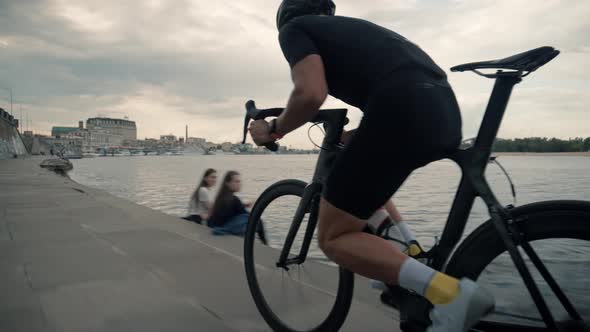 Cyclist In Helmet Riding On Sunset On Triathlon Time Trial Bicycle. Cycling On Sunset Time Or Dusk.