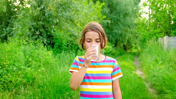 The Child Drinks Water From a Glass