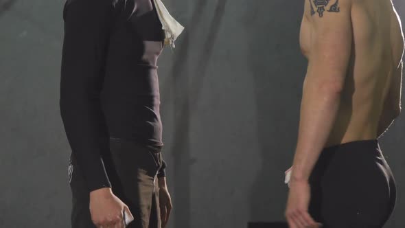 Cropped Shot of Two Athletic Men Bumping Fists at the Gym