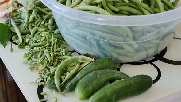 Organic garden vegetables close-up, fresh beans and cucumbers, growing natural produce,	