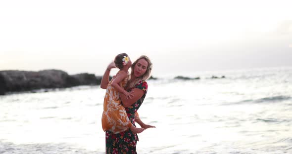 A mother and daughter enjoy some time together at a beach in Hawaii (Maui).