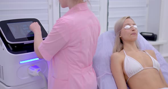 Young Woman Lies in Safety Glasses a Laser Hair Removal Procedure in a Beauty Salon
