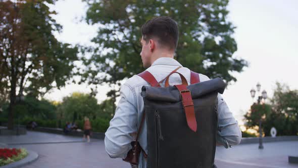 Attractive Young Handsome Man Tourist with Backpack Walking in City Center