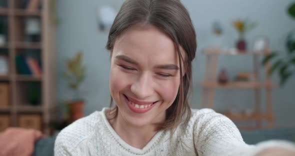 Close Up View of Smiling Woman Having Video Call and Using Frontal Camera of Smartphone. Young