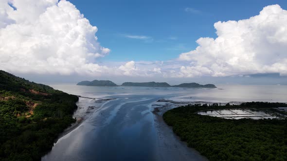 Aerial silhouette at river toward sea.