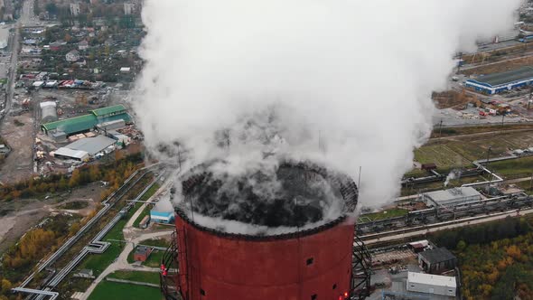 Steam Flows Above Red Cooling Tower at Heat Power Station