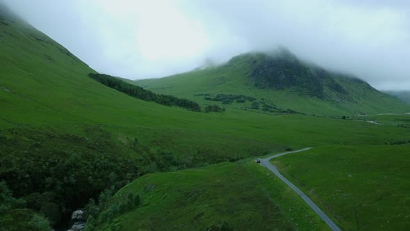 A country road track in the midst of countryside in gloomy clouds