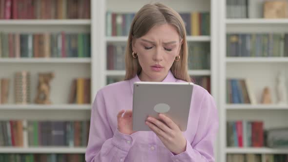 Portrait of Woman Having Loss on Tablet in Office