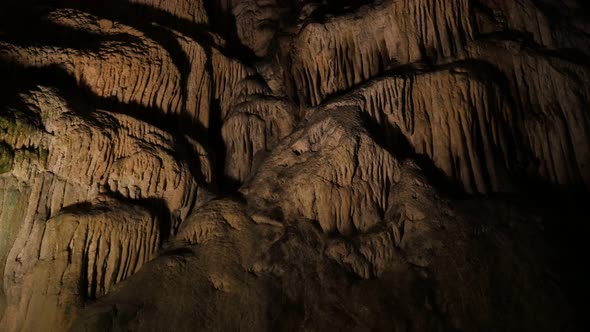 Slow tilt on ancient formations of stalactites and stalagmites 3840X2160 UHD footage - Area deep ins