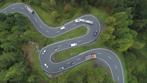 Winding road with hairpins and traffic at Maloja pass, Switzerland