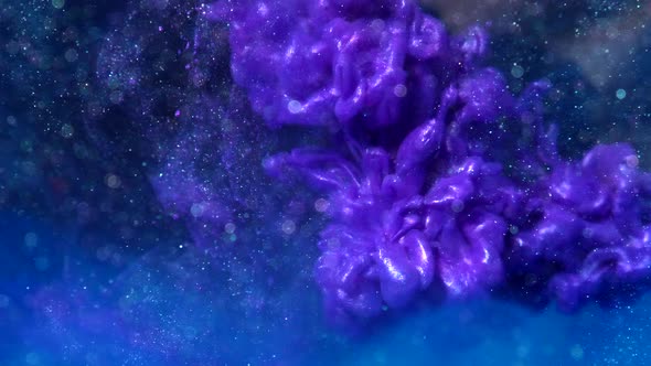 Abstract metallic purple luminescent ink drop chemical in a liquid water solution with particles on