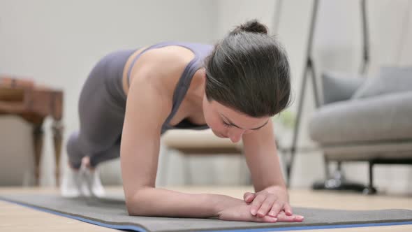 Young Indian Woman Doing Plank on Yoga Mat at Home