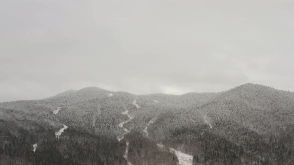 Vast mountainous landscape dusted with fresh snowfall Aerial