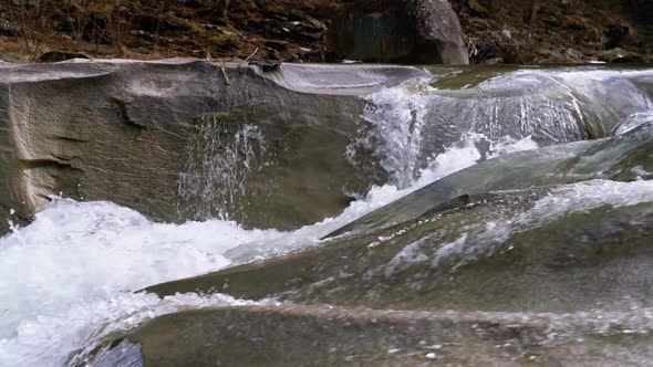 Wild Mountain River Flowing with Stone Boulders and Stone Rapids. Slow Motion