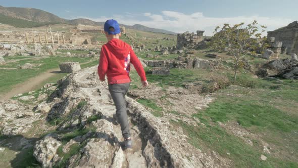 Child Discovering Ancient City and Walking Among the Ruins. Pamukkale, Turkey