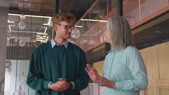 Happy and Excited Teacher and Student Giving High Five Standing in Office