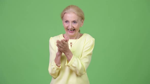 Happy Senior Businesswoman Clapping Hands