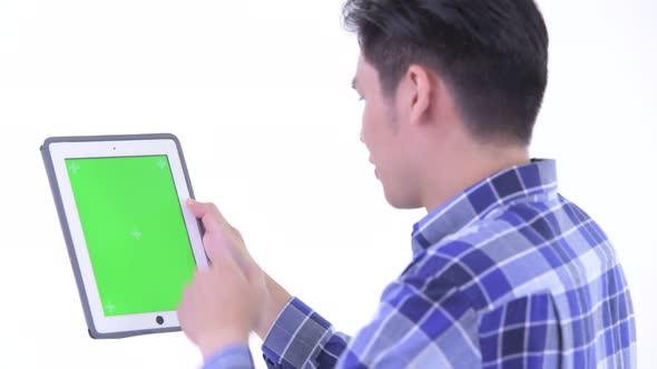 Closeup Rear View of Young Asian Hipster Man Using Digital Tablet